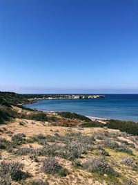 Scenic view of sea against clear blue sky