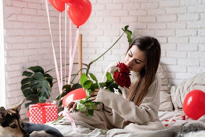 Side view of girl playing with bouquet