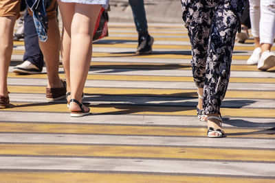 Low section of people walking on road