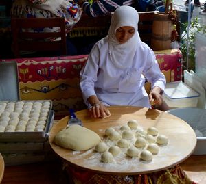 Woman wearing hijab preparing food in bakery