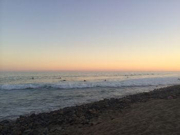 Scenic view of sea against clear sky during sunset
