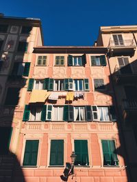 Low angle view of building against clear blue sky