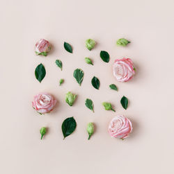 Directly above shot of christmas decorations on pink background