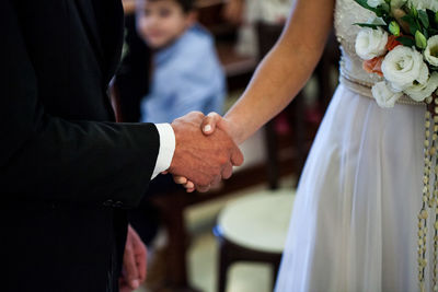 Close-up of couple holding hands