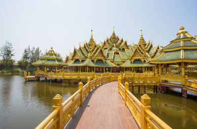 Temple by building against clear sky