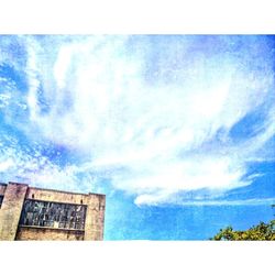 Low angle view of built structure against cloudy sky