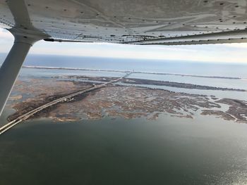 Close-up of beach against sky during sunset
