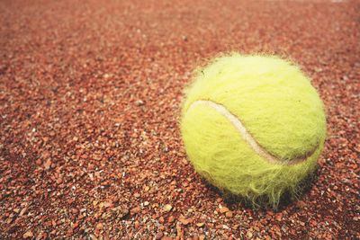 Close-up of yellow ball on field