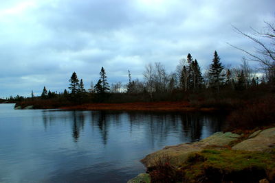 Scenic view of lake against cloudy sky