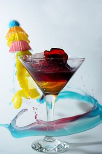 Close-up of drink served on table against white background