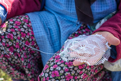 Midsection of woman holding art and craft product