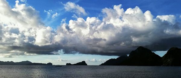 Scenic view of mountains against cloudy sky