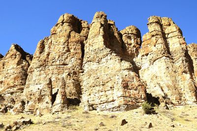 Low angle view of rock formation on sunny day