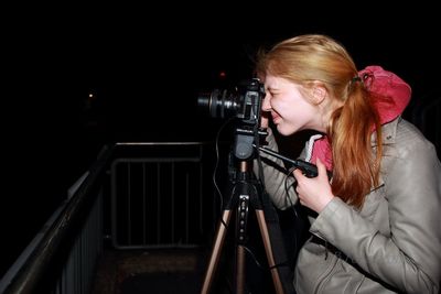 Close-up of woman photographing in darkroom