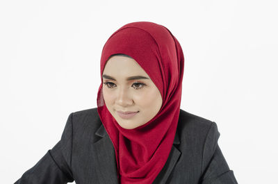 Portrait of beautiful young woman against white background