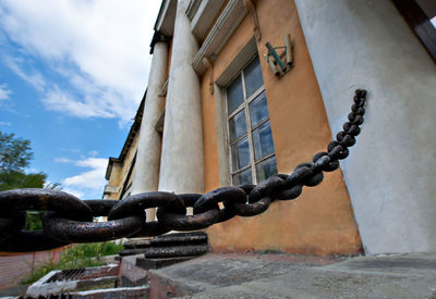 Chain fence attached to building wall