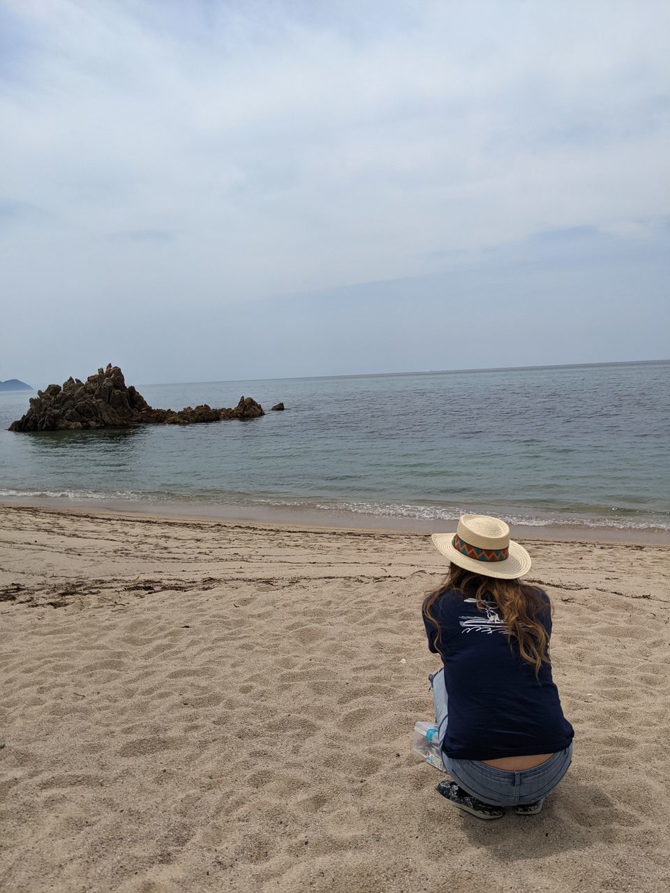 REAR VIEW OF HAT ON BEACH