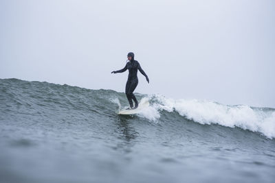 Woman surfing during winter snow