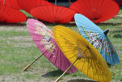 Multi colored open umbrellas on field