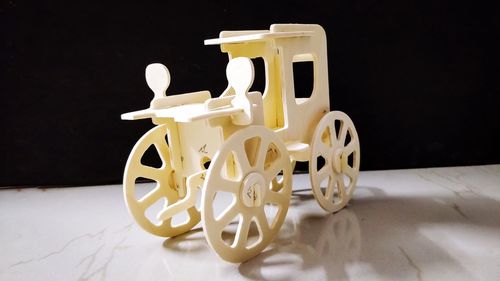 Close-up of toy car on table against black background