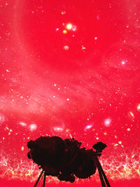 Low angle view of red light against sky at night