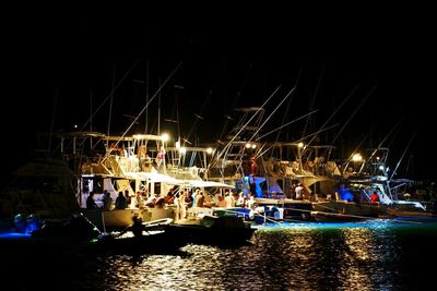 Boats in calm sea at night