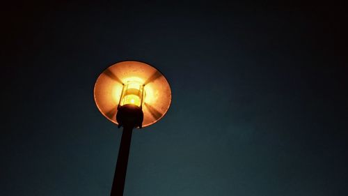 Low angle view of illuminated light bulb