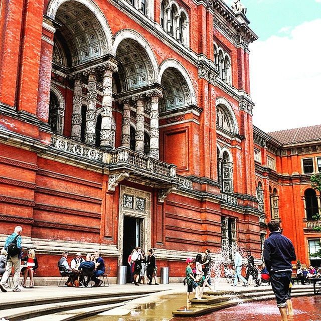 building exterior, architecture, built structure, person, arch, men, facade, lifestyles, street, walking, history, leisure activity, entrance, city, large group of people, window, day, outdoors, travel destinations