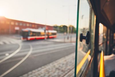 Tram on street in city seen through window