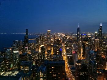 High angle view of city lit up at night