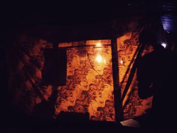 High angle view of illuminated lamp in dark room