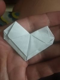 Close-up of human hand holding paper