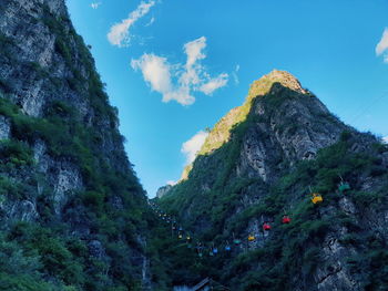 Low angle view of mountain against blue sky