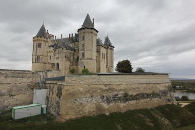 Historic building against cloudy sky