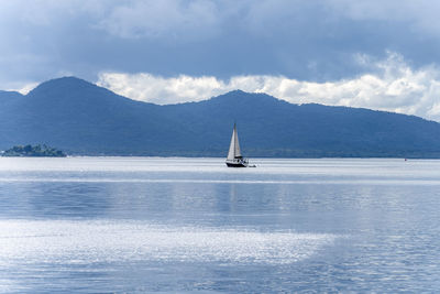 Sailboat on sea against sky