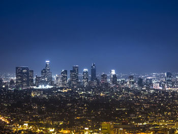 Aerial view of city lit up at night