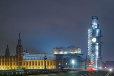 Illuminated buildings against sky at night