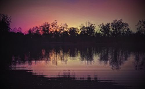 Scenic view of lake against romantic sky at sunset