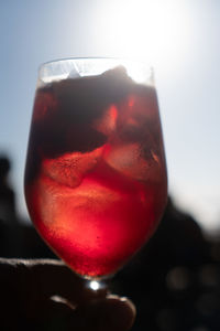 Close-up of beer in glass against sky