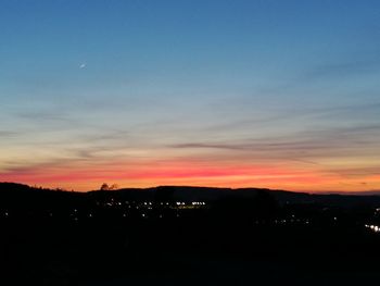 Silhouette landscape against sky during sunset