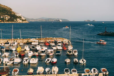 High angle view of sailboats in sea against clear sky