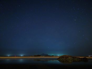 Scenic view of lake against star field at night