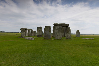 Rocks on field against sky