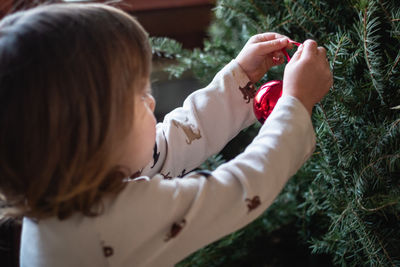 Side view of woman holding flowers
