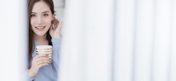 Young woman drinking water from glass