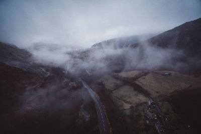 Scenic view of mountains against cloudy sky