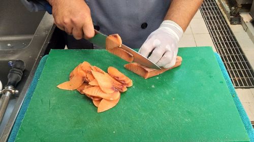 High angle view of man preparing food on cutting board