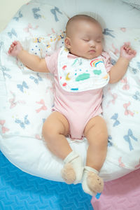 Portrait of cute baby boy sleeping on bed