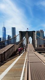 Suspension bridge with buildings in background