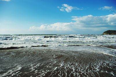 Scenic view of sea against cloudy sky